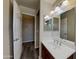 Bathroom showcasing vanity, modern lighting, and doorway leading to another section of the bathroom at 17914 N Fiano Dr, Maricopa, AZ 85138