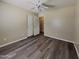 Bedroom with modern ceiling fan, closet, and wood-look floors, bathed in natural light at 17914 N Fiano Dr, Maricopa, AZ 85138