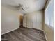 Bedroom featuring a modern ceiling fan, sliding closet and window to the room with wood-look flooring at 17914 N Fiano Dr, Maricopa, AZ 85138