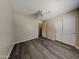 Bedroom featuring a modern ceiling fan, sliding closet and window to the room with wood-look flooring at 17914 N Fiano Dr, Maricopa, AZ 85138