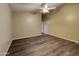 Inviting bedroom with dark plank flooring, ceiling fan, and ample natural light at 17914 N Fiano Dr, Maricopa, AZ 85138