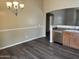 The dining room features modern vinyl floors, neutral walls, a modern chandelier, and lots of natural light at 17914 N Fiano Dr, Maricopa, AZ 85138