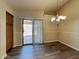 Bright dining room with dark plank flooring and sliding glass door access to the patio at 17914 N Fiano Dr, Maricopa, AZ 85138