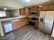 Well-equipped kitchen with stainless steel appliances, and hardwood cabinets at 17914 N Fiano Dr, Maricopa, AZ 85138