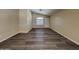 Spacious living room boasts modern dark plank flooring, neutral walls, and natural light at 17914 N Fiano Dr, Maricopa, AZ 85138