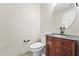 Bathroom featuring a vanity with dark wood cabinets, a decorative sink, and a toilet at 18250 N Cave Creek Rd # 105, Phoenix, AZ 85032