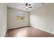 This simple bedroom has a window that lets in natural light and hardwood-style flooring at 18250 N Cave Creek Rd # 105, Phoenix, AZ 85032