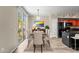 Stylish dining area with sleek furniture, a bright painting, and a view to the sliding glass doors at 18250 N Cave Creek Rd # 105, Phoenix, AZ 85032