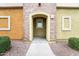 Condo entrance featuring an arched doorway and unit number 105, with low maintenance landscaping at 18250 N Cave Creek Rd # 105, Phoenix, AZ 85032