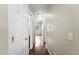 Hallway with wood-look floors, white trim, and doors, illuminated by a ceiling light at 18250 N Cave Creek Rd # 105, Phoenix, AZ 85032