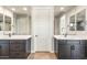 Modern bathroom with double vanity sinks, quartz countertops and a view through a large mirror at 18742 N 269Th Ln, Buckeye, AZ 85396