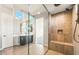 Luxurious bathroom featuring tiled shower with built-in bench and high-end fixtures at 18742 N 269Th Ln, Buckeye, AZ 85396