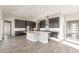 Modern kitchen featuring a large center island, sleek countertops, and custom cabinetry at 18742 N 269Th Ln, Buckeye, AZ 85396