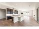 Well-lit kitchen with stainless steel appliances, large cabinets, and center island at 18742 N 269Th Ln, Buckeye, AZ 85396