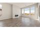 Spacious living room featuring modern fireplace, expansive windows with mountain views, and tile floors at 18742 N 269Th Ln, Buckeye, AZ 85396