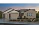 Charming single-story home boasting a three-car garage, neutral palette, and desert landscaping at 18882 E Celtic Manor Dr, Queen Creek, AZ 85142