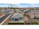 Charming home aerial view showcasing desert landscaping, a small green lawn, covered patio, and neighborhood view at 2013 E Brooklyn Dr, Casa Grande, AZ 85122