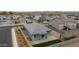 Charming home aerial view featuring desert landscaping, green lawn, covered patio, and neighborhood views at 2013 E Brooklyn Dr, Casa Grande, AZ 85122