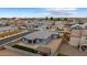 Charming home aerial view showcasing desert landscaping, a small green lawn, covered patio, and neighborhood view at 2013 E Brooklyn Dr, Casa Grande, AZ 85122