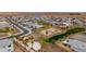 Community aerial view featuring homes, palm trees, playground, basketball court, and volleyball court in desert landscape at 2013 E Brooklyn Dr, Casa Grande, AZ 85122