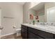 Bathroom featuring a double vanity with granite countertops, a toilet, and wood-look flooring at 2013 E Brooklyn Dr, Casa Grande, AZ 85122