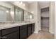 Modern bathroom featuring a double vanity with granite countertops and a walk-in closet at 2013 E Brooklyn Dr, Casa Grande, AZ 85122