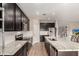 Modern kitchen with dark cabinetry, stainless steel appliances, a large island, and white subway tile backsplash at 2013 E Brooklyn Dr, Casa Grande, AZ 85122