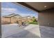 Covered backyard patio with outdoor seating area, offering relaxing views of the green yard and neighborhood at 22644 E Quintero Ct, Queen Creek, AZ 85142