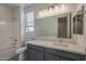 Bathroom featuring a white tub and shower combination, window, and grey vanity at 22644 E Quintero Ct, Queen Creek, AZ 85142