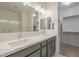 Bathroom featuring double sinks with white countertops, grey vanity, and walk-in shower at 22644 E Quintero Ct, Queen Creek, AZ 85142