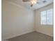 This bedroom offers a ceiling fan, a window for natural light, and neutral carpet at 22644 E Quintero Ct, Queen Creek, AZ 85142