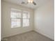 Well-lit bedroom featuring neutral walls, carpet, and two windows with horizontal blinds at 22644 E Quintero Ct, Queen Creek, AZ 85142