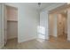 Bright bedroom featuring a walk-in closet and light hardwood floors, offering plenty of storage at 22644 E Quintero Ct, Queen Creek, AZ 85142