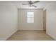 Bright bedroom featuring a ceiling fan, light hardwood floors, and a window for natural light at 22644 E Quintero Ct, Queen Creek, AZ 85142