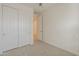 Carpeted bedroom with a double door closet and an open doorway at 22644 E Quintero Ct, Queen Creek, AZ 85142