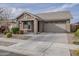 An inviting one-story home features a two-car garage, neutral tones, and tidy landscaping at 22644 E Quintero Ct, Queen Creek, AZ 85142