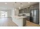 Modern kitchen with an island, stainless steel appliances and a patio door at 22644 E Quintero Ct, Queen Creek, AZ 85142