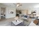 Bright, open-concept living room with modern decor flowing into a dining and kitchen space at 22644 E Quintero Ct, Queen Creek, AZ 85142