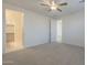 Spacious carpeted main bedroom featuring a ceiling fan and an open doorway to the closet at 22644 E Quintero Ct, Queen Creek, AZ 85142