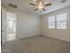 Bright main bedroom with carpet, ceiling fan, and two windows allowing natural light at 22644 E Quintero Ct, Queen Creek, AZ 85142