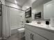 Modern bathroom featuring white vanity, shower and tub combo, with neutral paint throughout at 22808 E Roundup Way, Queen Creek, AZ 85142