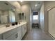 Bright bathroom with double sinks, white cabinetry, and a walk-in shower, providing a clean and functional space at 22808 E Roundup Way, Queen Creek, AZ 85142