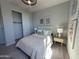 Cozy bedroom featuring neutral walls, a ceiling fan, and a window with natural light at 22808 E Roundup Way, Queen Creek, AZ 85142