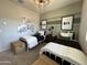 Shared bedroom featuring twin beds, neutral carpet, striped walls and matching wall art at 22808 E Roundup Way, Queen Creek, AZ 85142