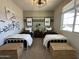 Shared bedroom featuring twin beds, neutral carpet and a unique black industrial ceiling fan at 22808 E Roundup Way, Queen Creek, AZ 85142