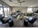 Bright and airy living room with neutral tones, stylish furnishings, and a view of the outdoor space through sliding glass doors at 22808 E Roundup Way, Queen Creek, AZ 85142