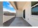 Back patio provides a concrete surface and a view of the gravel backyard and block wall at 24220 W Ripple Rd, Buckeye, AZ 85326