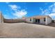 Spacious backyard with gravel landscaping, patio, and block wall offers privacy and low maintenance at 24220 W Ripple Rd, Buckeye, AZ 85326