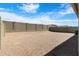 Wide view of gravel backyard with a high block wall, offering privacy and space at 24220 W Ripple Rd, Buckeye, AZ 85326