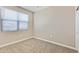 Empty bedroom featuring neutral walls, carpet flooring, a window, and ample natural light at 24220 W Ripple Rd, Buckeye, AZ 85326